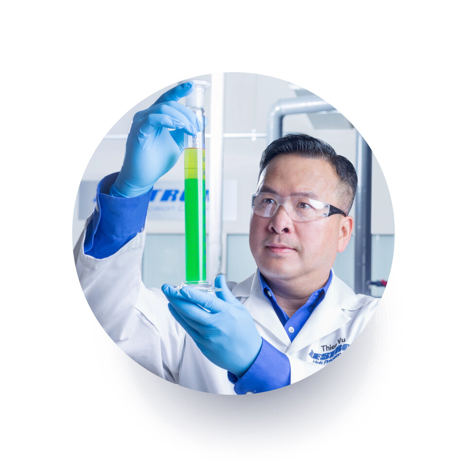 zestron engineer thein vu looking into test beaker with chemistry