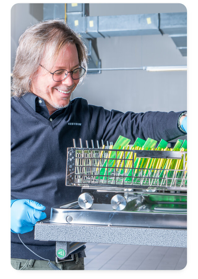 Axel Vargas Eastern USA Regional Sales Manager using batch machine to clean pcb